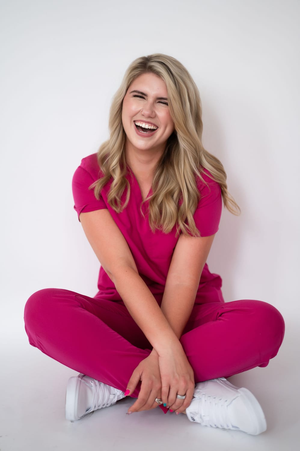 Burnout Coach Mary wearing pink scrubs