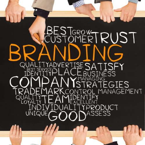 Multiple hands writing "BRANDING" on a chalkboard along with words like "Trust," "Strategies," and "Identity," symbolizing the collaborative process of personal branding and strategic positioning.