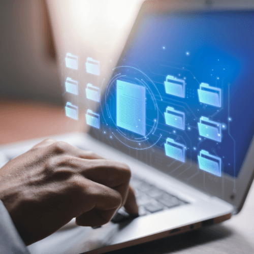 A person using a laptop with virtual folders and a document icon, representing business automation and workflow system setup services.