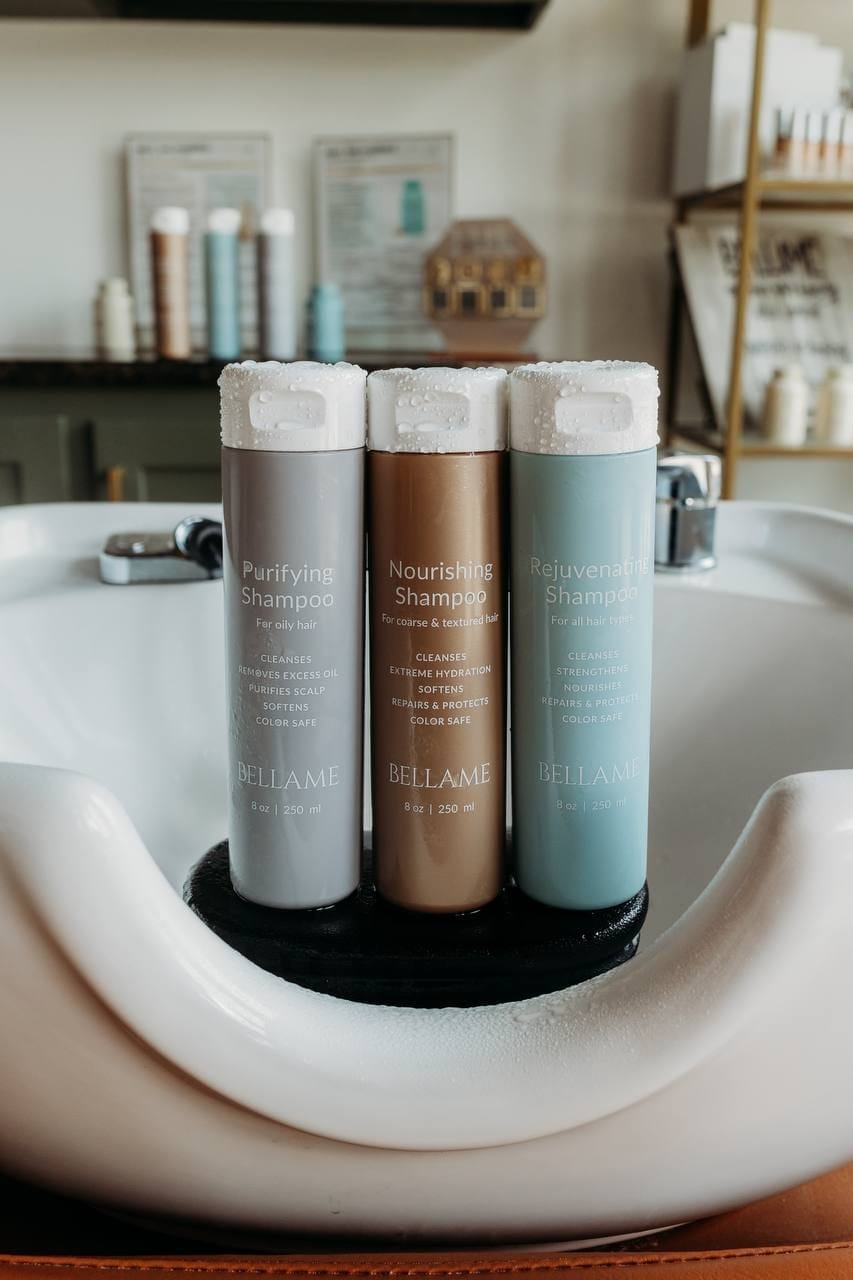 Bellame shampoo bottles displayed in hair stylist bowl