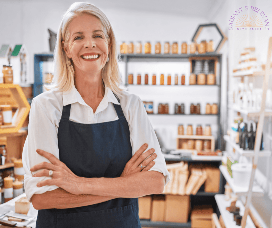 woman with arms crossed wearing apron and standing in a boutique