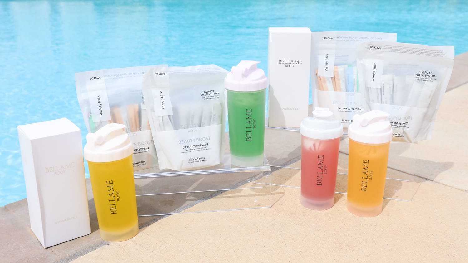 picture of Bellame's Glow Juice Collection by the pool, packages and shaker cups
