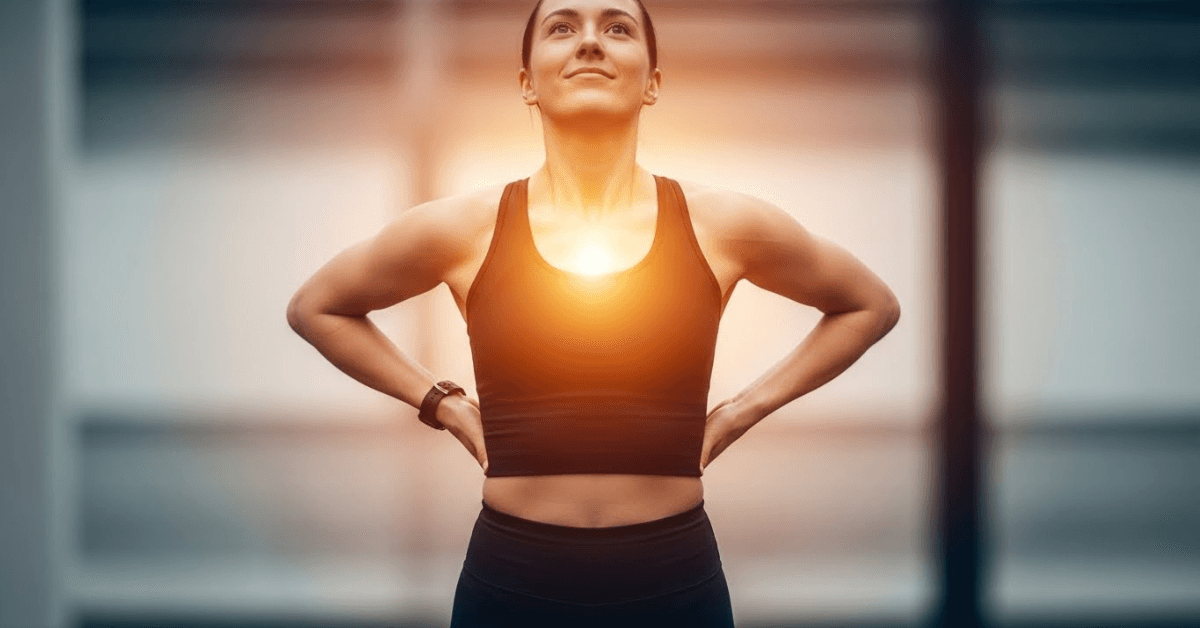 A person standing in a strong power pose with hands on hips and chest lifted, symbolizing an immediate surge of confidence and energy triggered by posture.