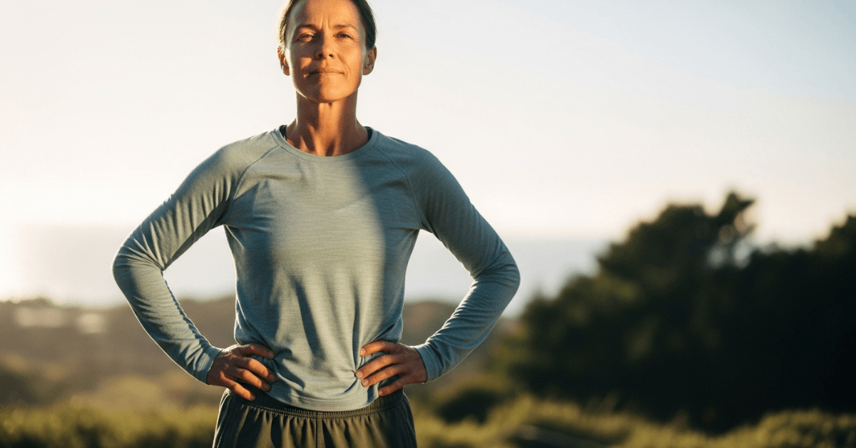 Confident woman standing outdoors with hands on hips, representing sustainable health built through consistent long-term habits