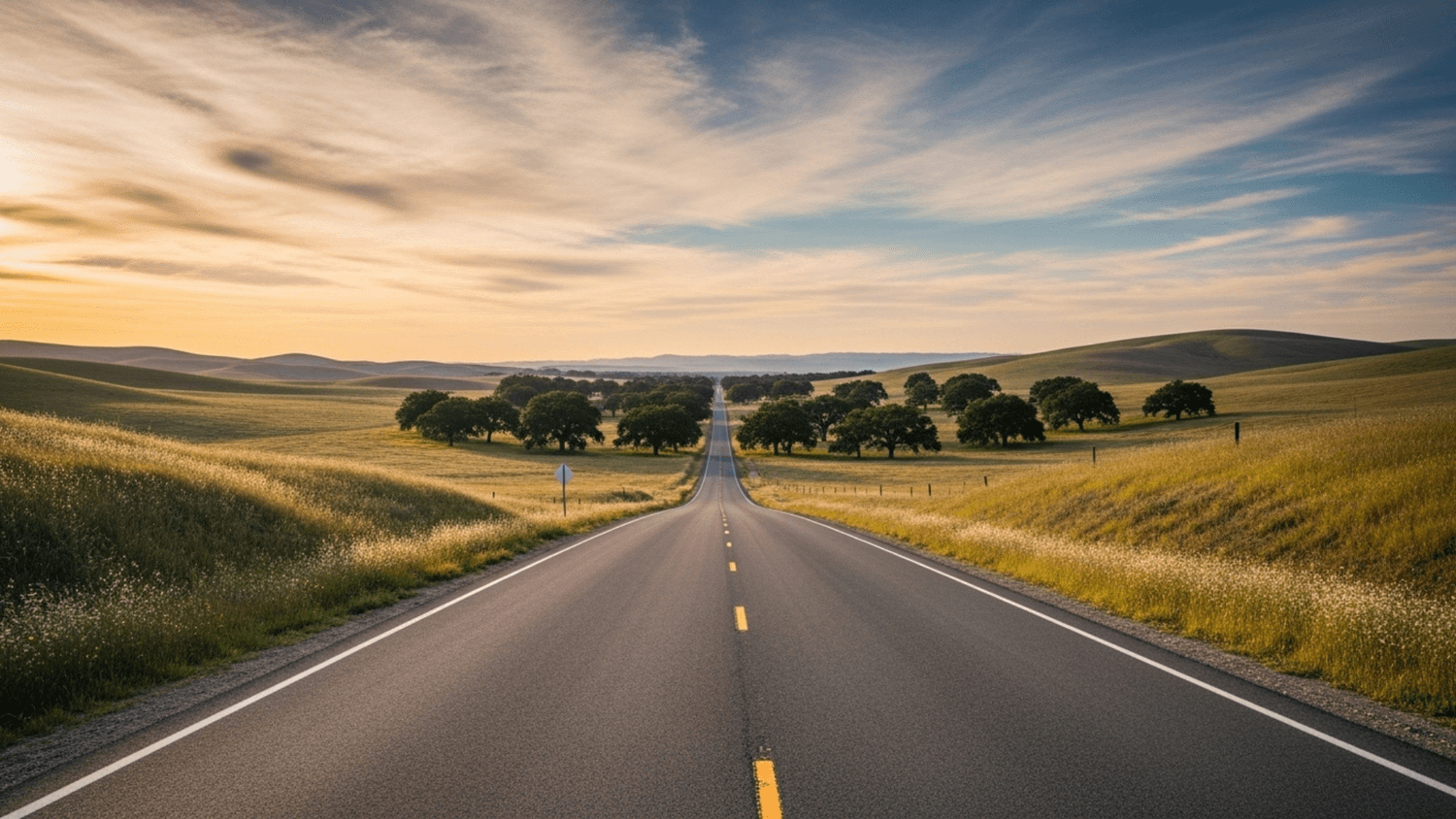 open road stretching into the distance through a wide landscape under a calm sky symbolizing freedom independence and new possibilities