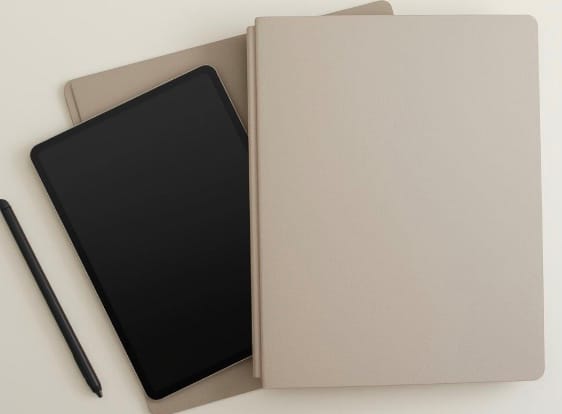 3 notebooks with pen on a desk