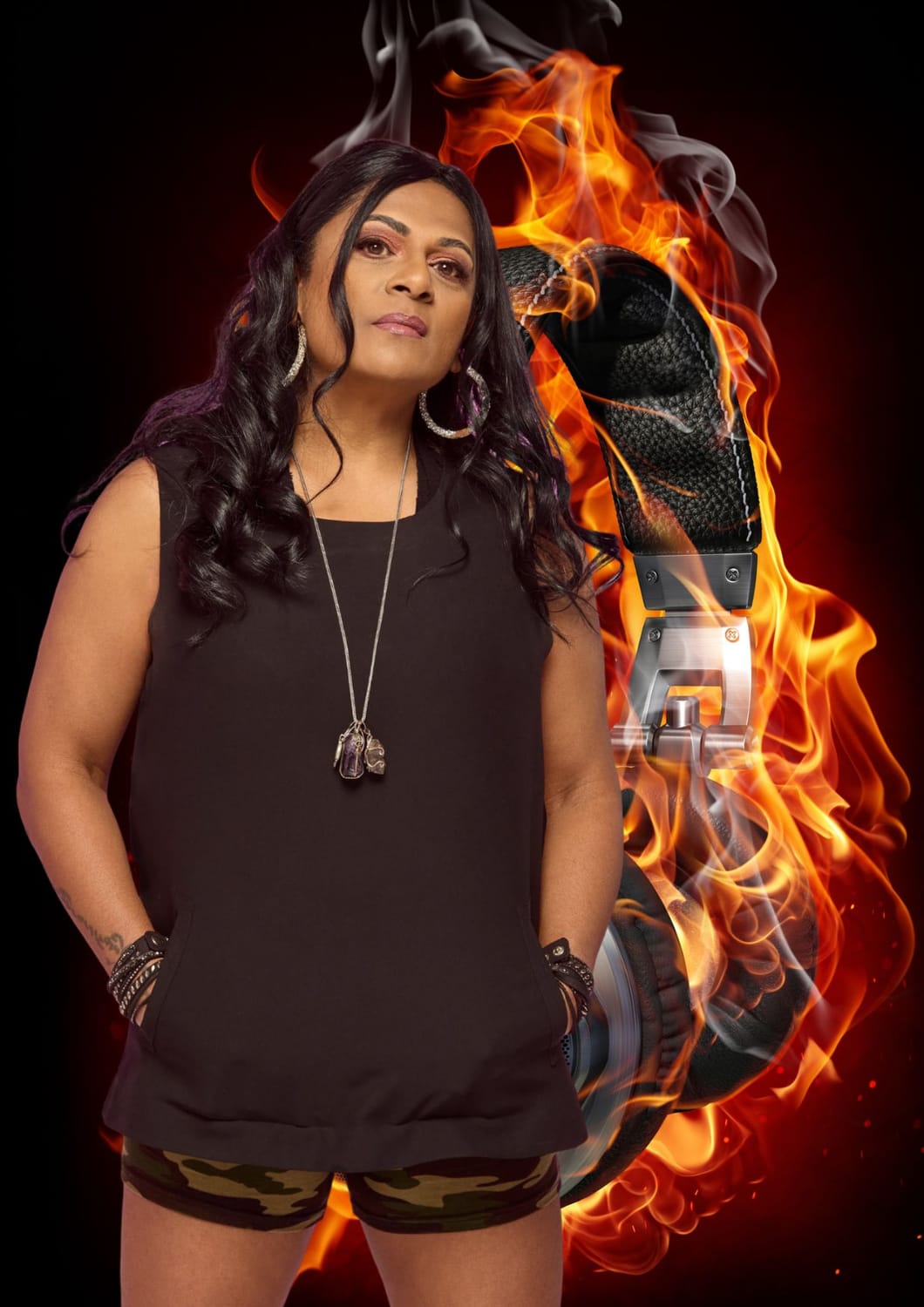 Sharm Pillay, award-winning international DJ, in a creative portrait celebrating her Lady of the House Demo competition win, featuring oversized headphones and flames.