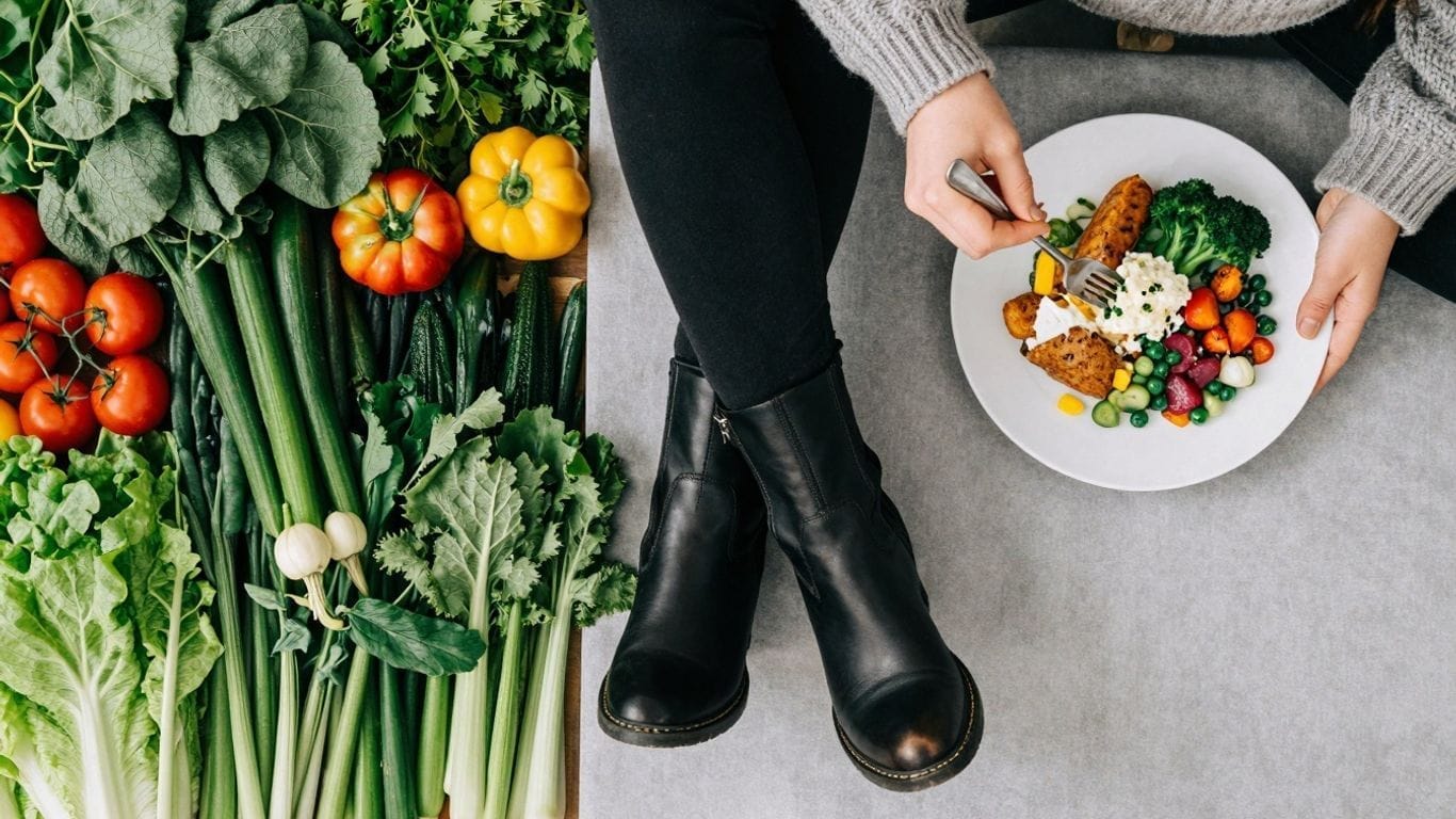 Vegan vs. vegetarian lifestyle comparison with food and clothing.