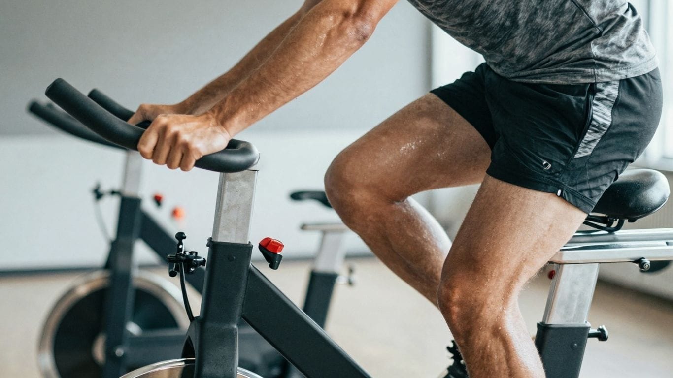 Person cycling intensely on a stationary bike.