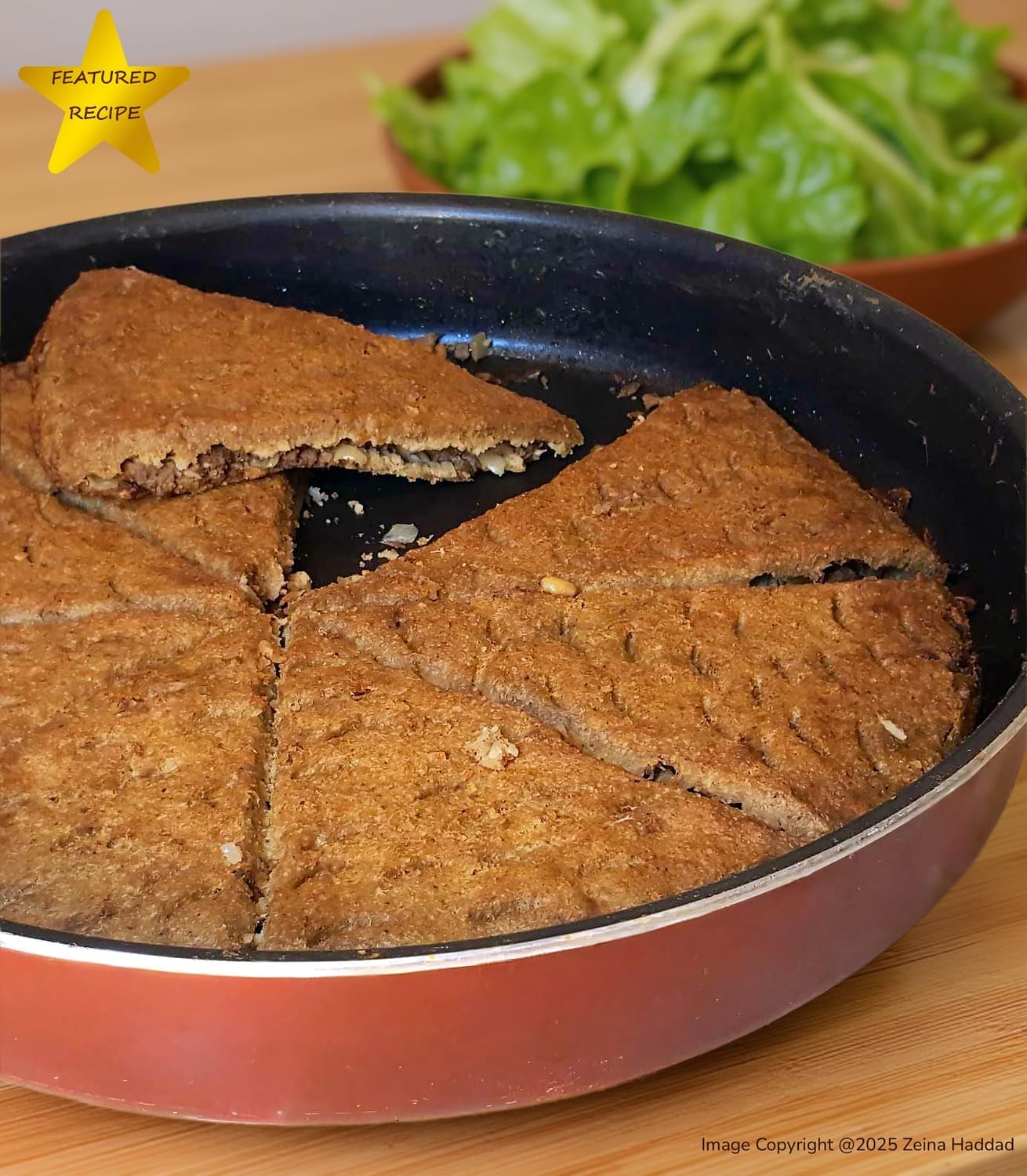 Golden brown authentic Lebanese Kibbeh bake in a round pan. A traditional savory meat and bulgur appetizer from the 'Main Dishes and Desserts' cookbook by Zeina Haddad.
