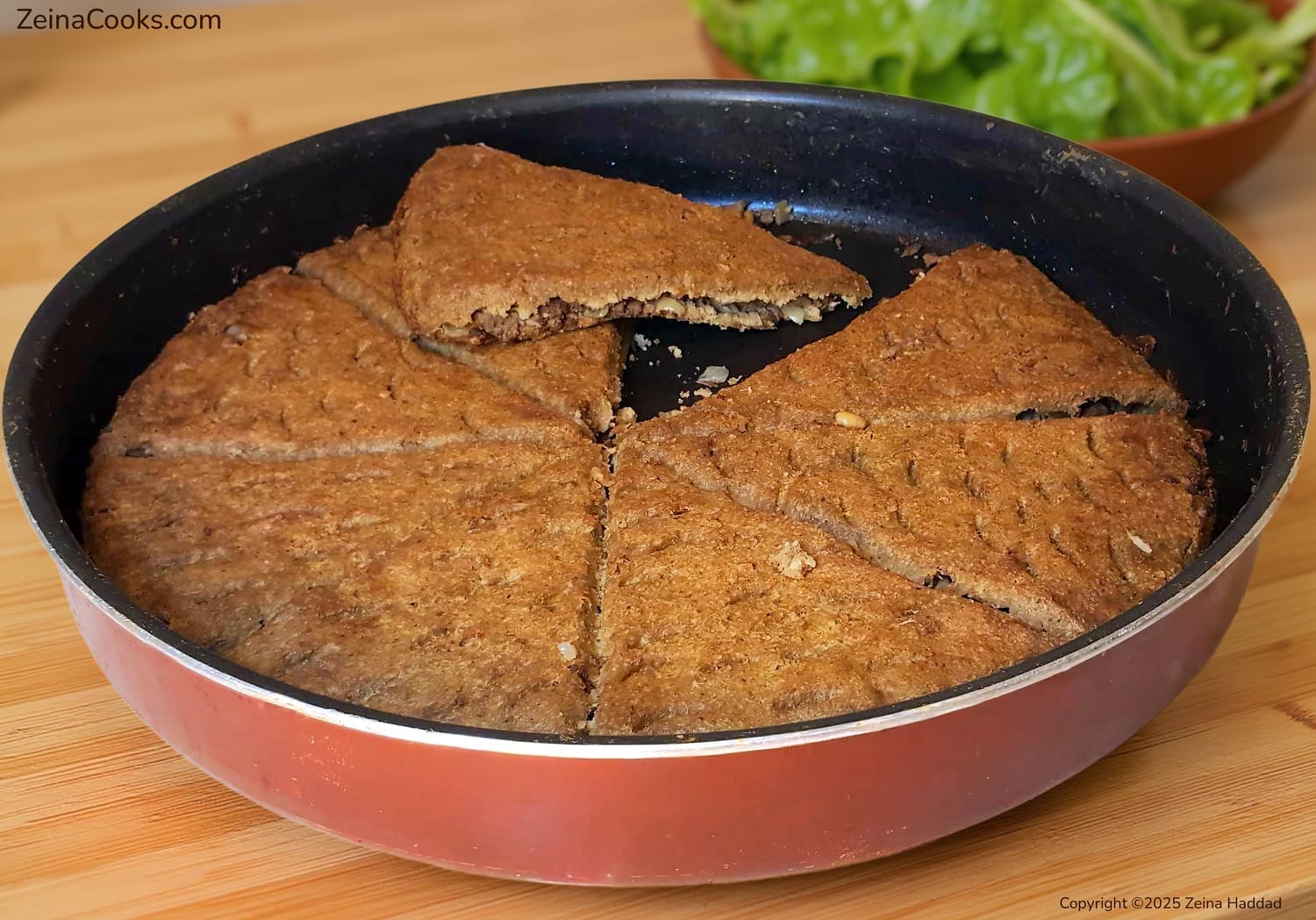 Close up texture of authentic Lebanese Kibbeh Bake cut open to show the savory Hashweh (spiced meat) filling and thin crispy bulgur layers from the 'Main Dishes and Desserts' cookbook by Zeina Haddad