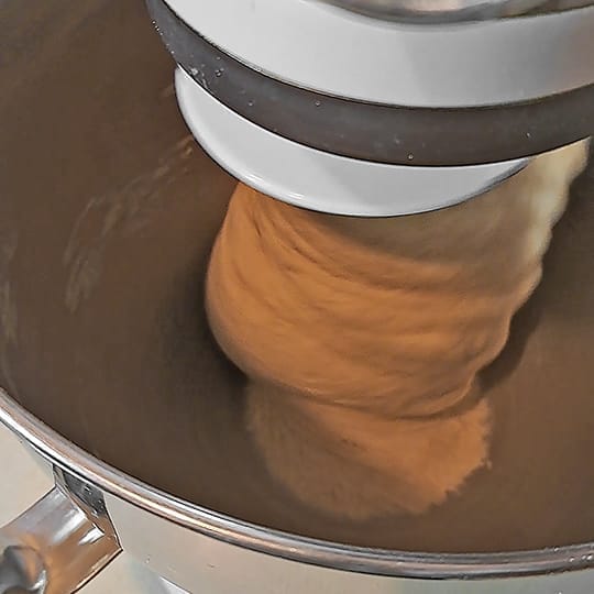 The dough for the 50/50 bread loaf being kneaded in the stand mixer and cleaning the sides of the bowl, for the 50/50 bread loaf by ZeinaCooks.com. by ZeinaCooks.com.