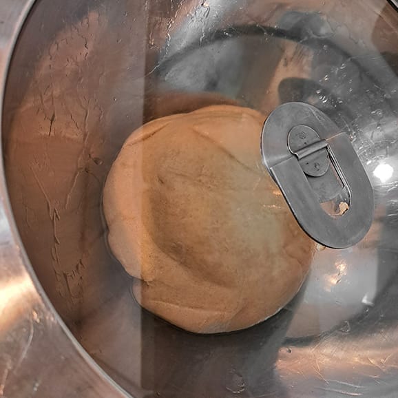 The dough for the 50/50 bread loaf gathered into a ball and placed in an oiled bowl and covered, by ZeinaCooks.com.