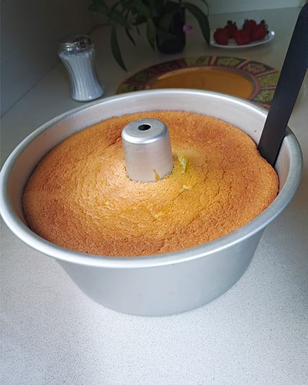 releasing the cake from the side of the pan with a spatula