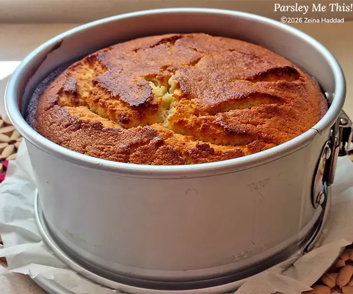 The cake "Zesty Lemon Butter Cake With Glaze" by Parsley Me This, fresh out of the oven and still in the springform pan.