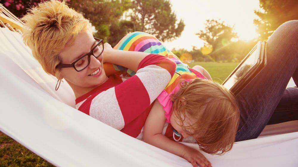 Happy mom with child outdoors, looking relaxed and free