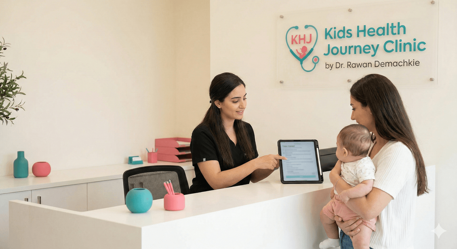 Reception assistant completing triage with a parent and baby at Kids Health Journey Clinic by Dr. Rawan Demachkie
