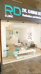 Reception assistant completing newborn intake with a parent and baby at Kids Health Journey Clinic by Dr. Rawan Demachkie