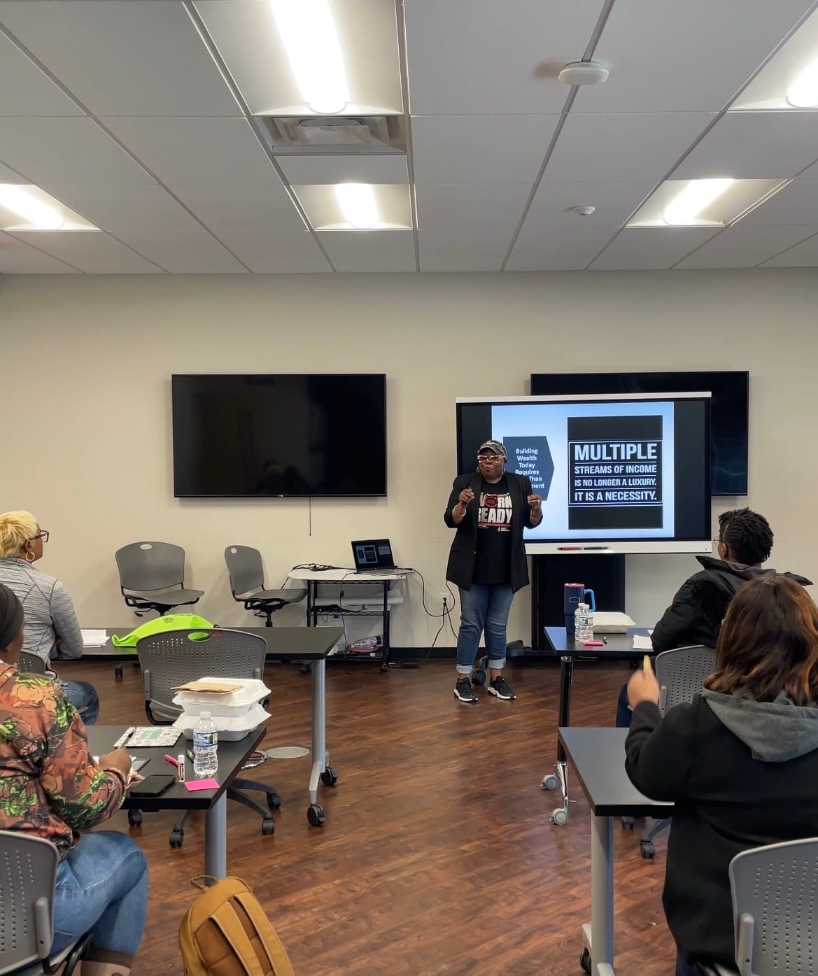 Chin Richardson teaching financial education to a live audience