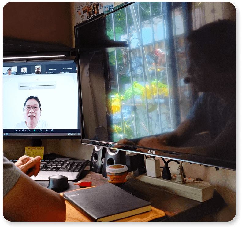 Advisor discussing a plan on a laptop with a client at a café; coffee cups on the table.
