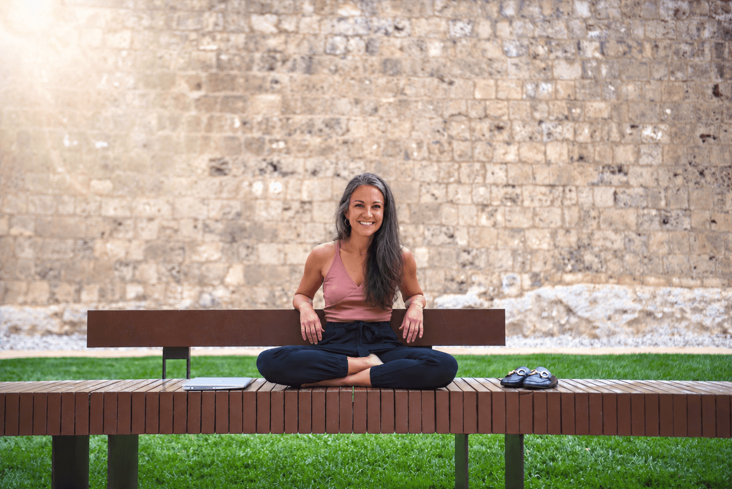 Gill Scerri smiling on a bench