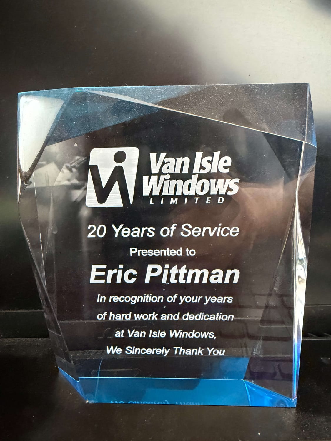 A 20-year service award presented to Eric Pittman by Van Isle Windows, recognizing two decades of leadership and sales success.