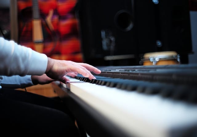 Child's hands playing piano at Sounds of Joy Music Studio - Rebecca Alderman