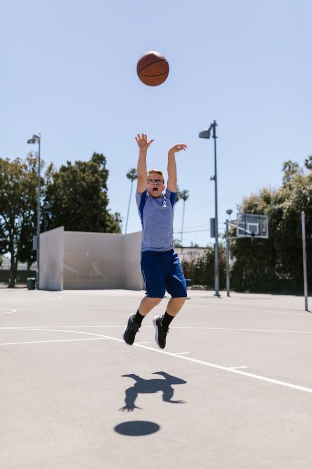 Boy using wrists to thrown a basketball - Sounds of Joy Music Studio