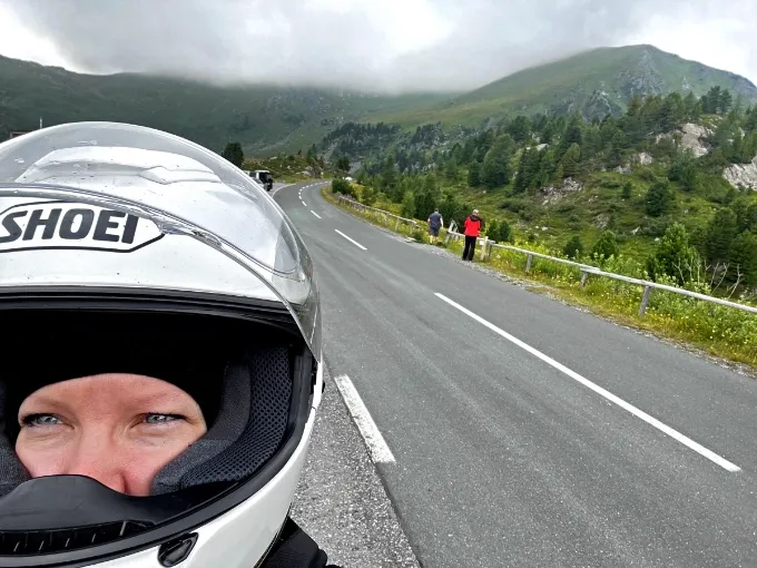 motorcycle rider looking back at a dramatic storm sky, symbolizing leaving anxiety, fear and emotional blocks behind for good