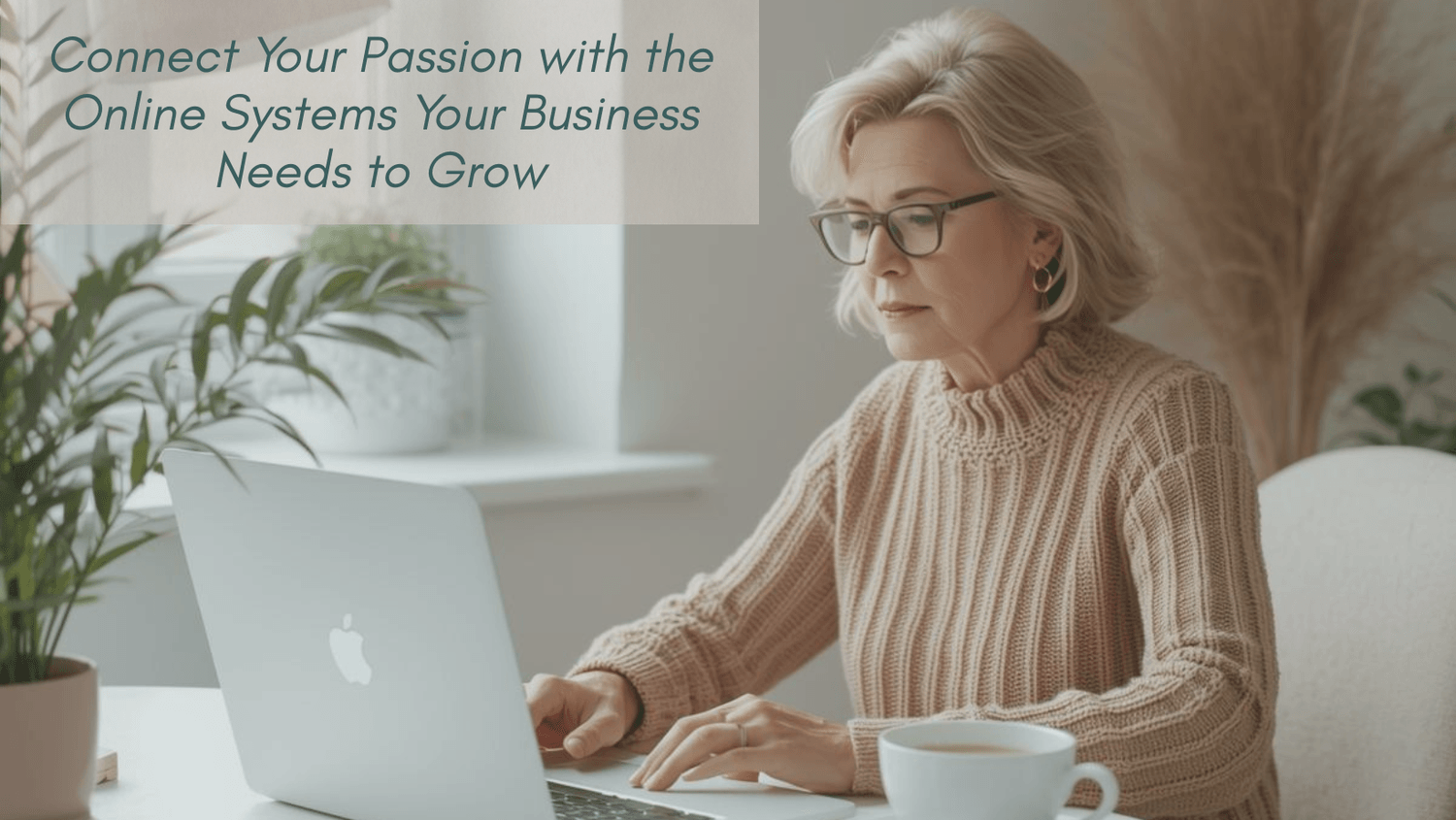 mature woman sitting at desk working on laptop with coffee beside her and plant next to laptop hero image for website