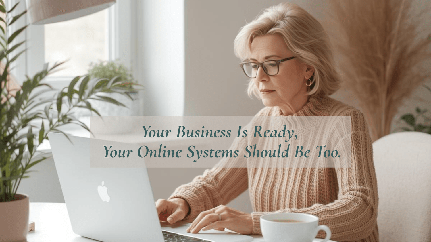mature woman entrepreneur working at desk with laptop and coffee