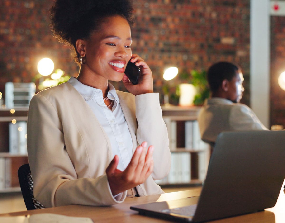 happy busineess women on a call in front of her laptop.jpg