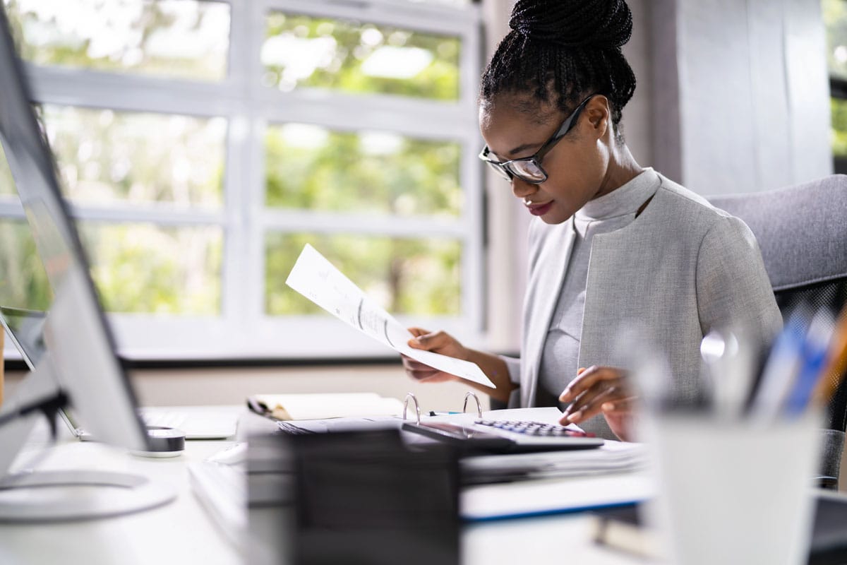 woman reviewing taxes and invoices and paperwork