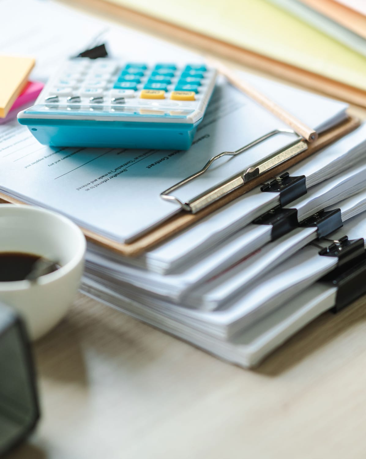 financial binder clips stacks with a calculator