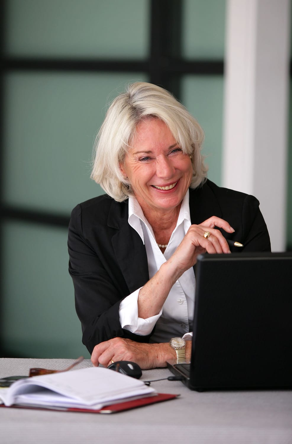 a woman on her smart phone while looking at a tablet