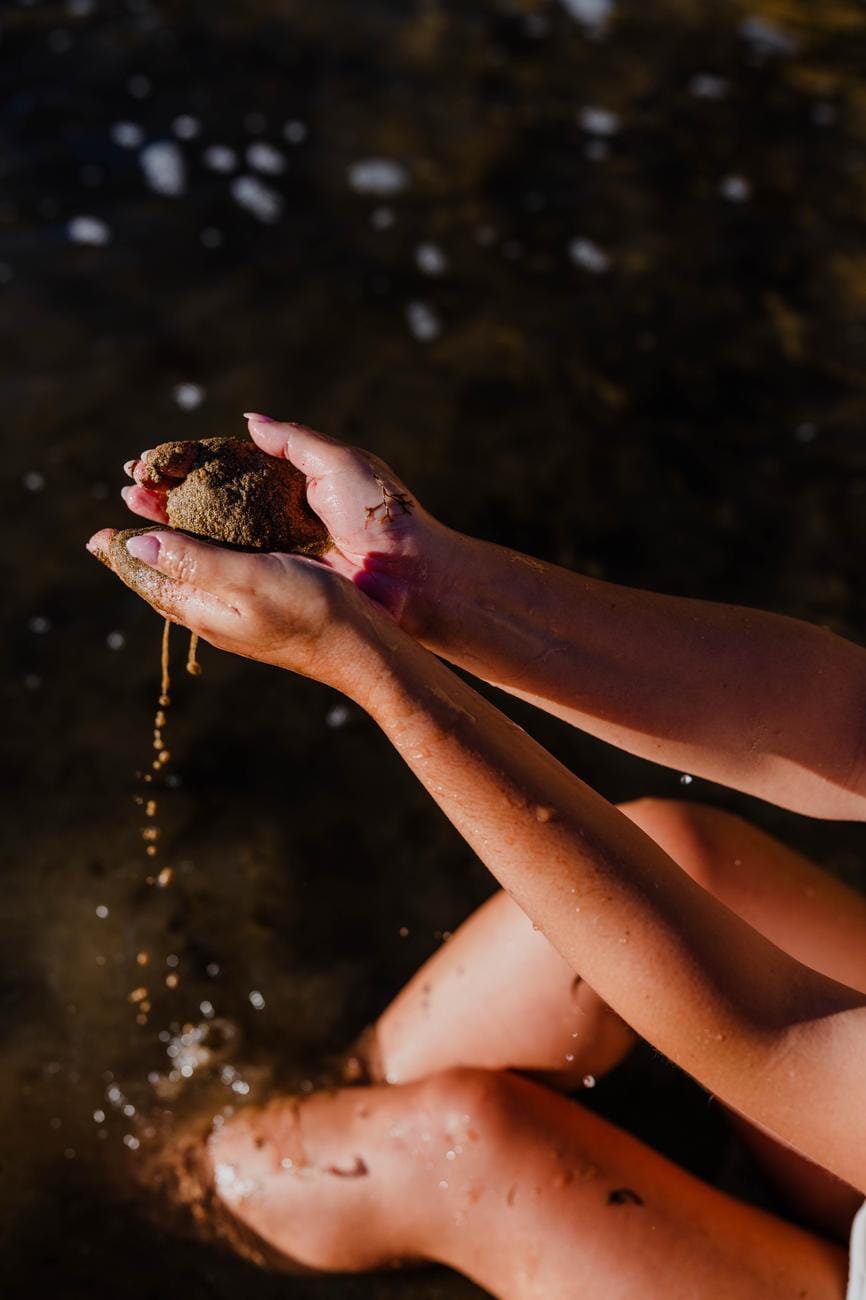 Hands holding wet sand