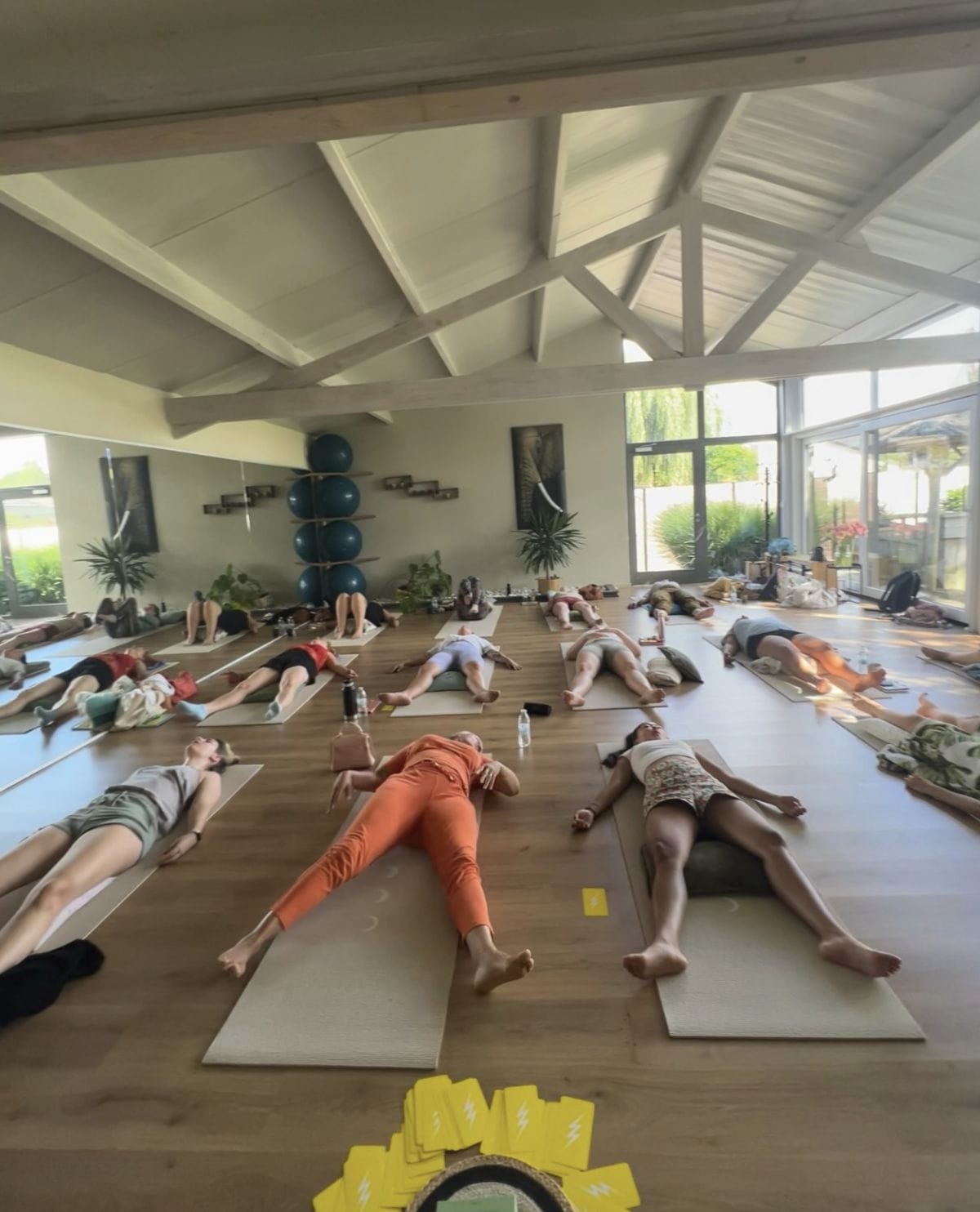A group lying on mats during a breathwork session