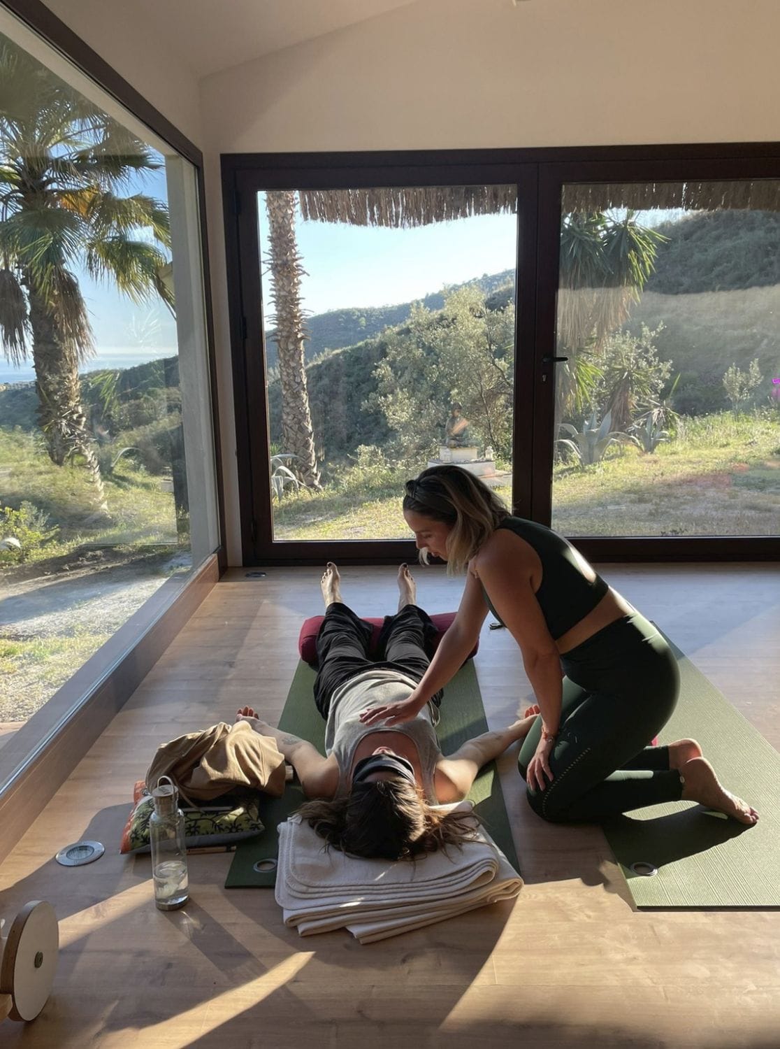 Valérie guiding a breathwork session by a large window