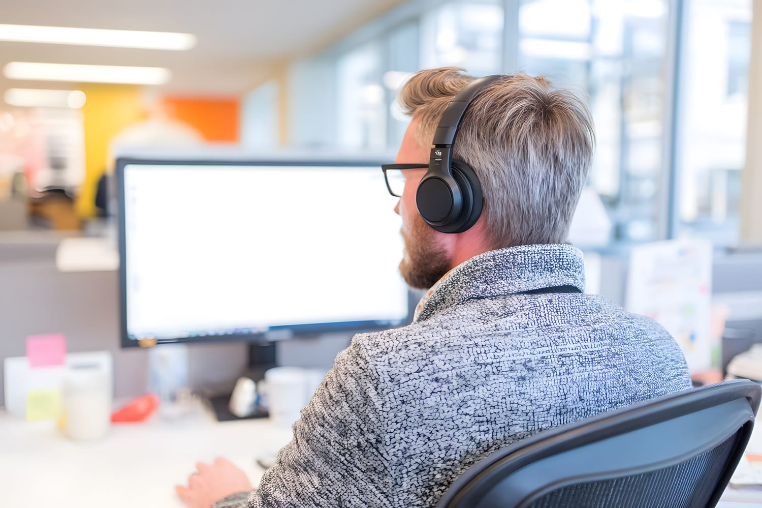 Image of a woman smiling while looking at a laptop