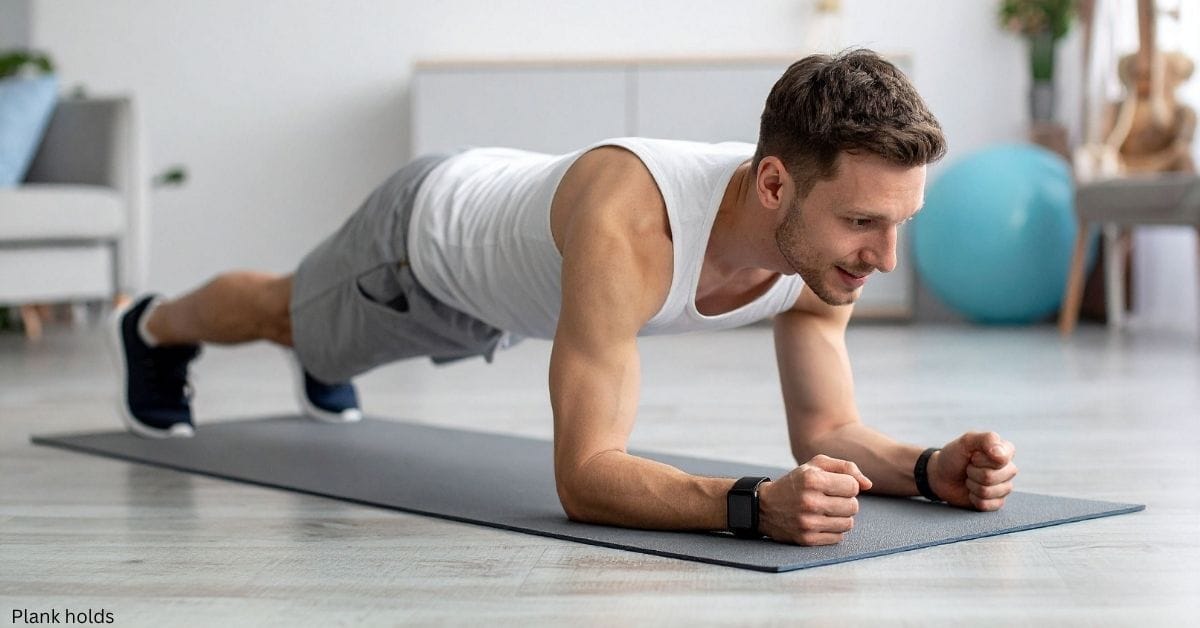 A young man performing the holding plank exercise