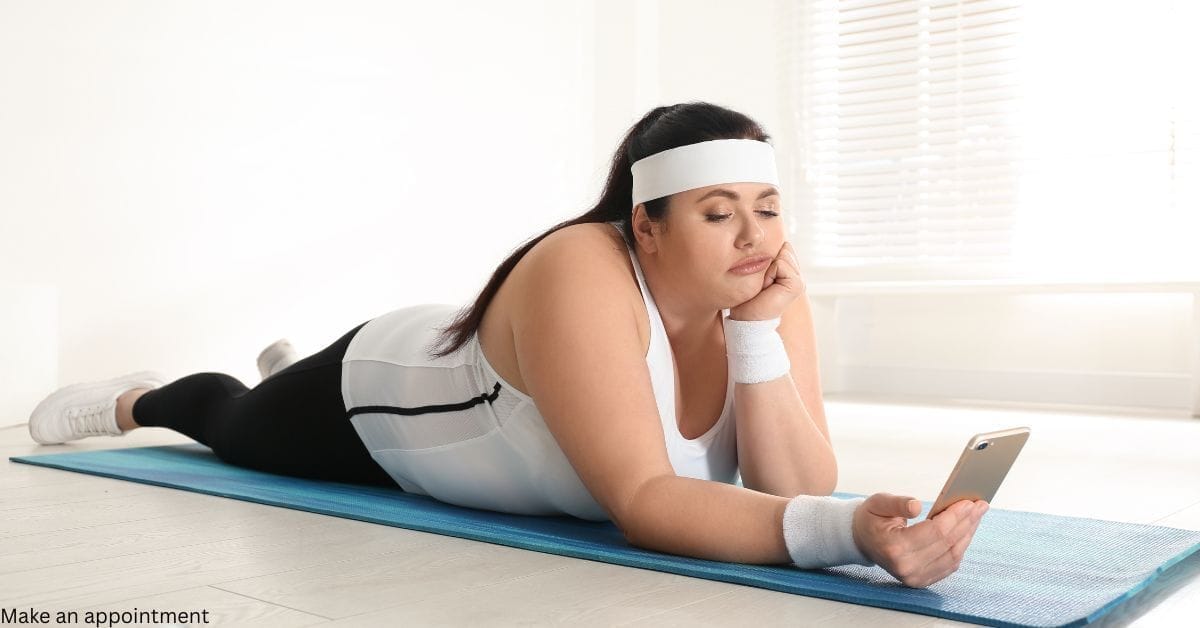 A woman looking at her phone calendar to see when her next exercise session is.