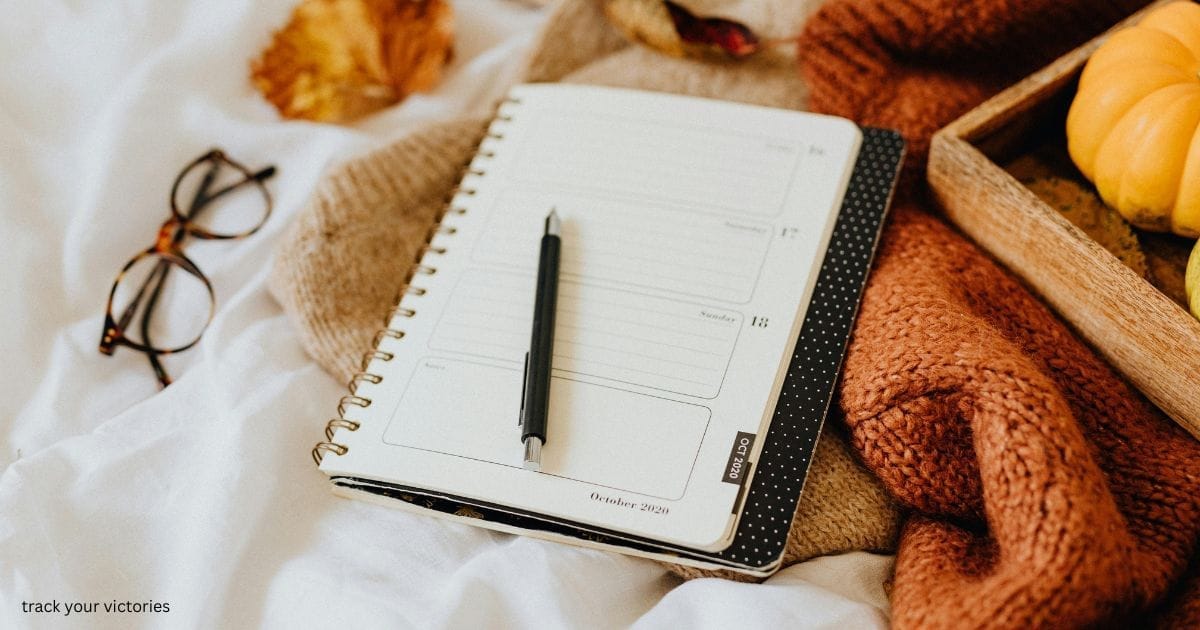 A pen, journal, and reading glasses to write down weight loss achievements