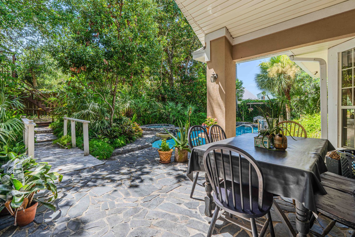Professional real estate photography of poolside cabanas and outdoor relaxation area at a premium Jacksonville residential
