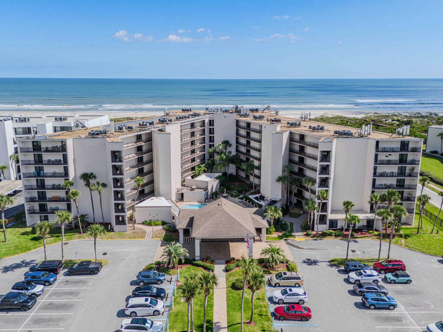 Aerial real estate photography showcasing a residential listing's proximity to local Florida parks and major transport links. Ocean view