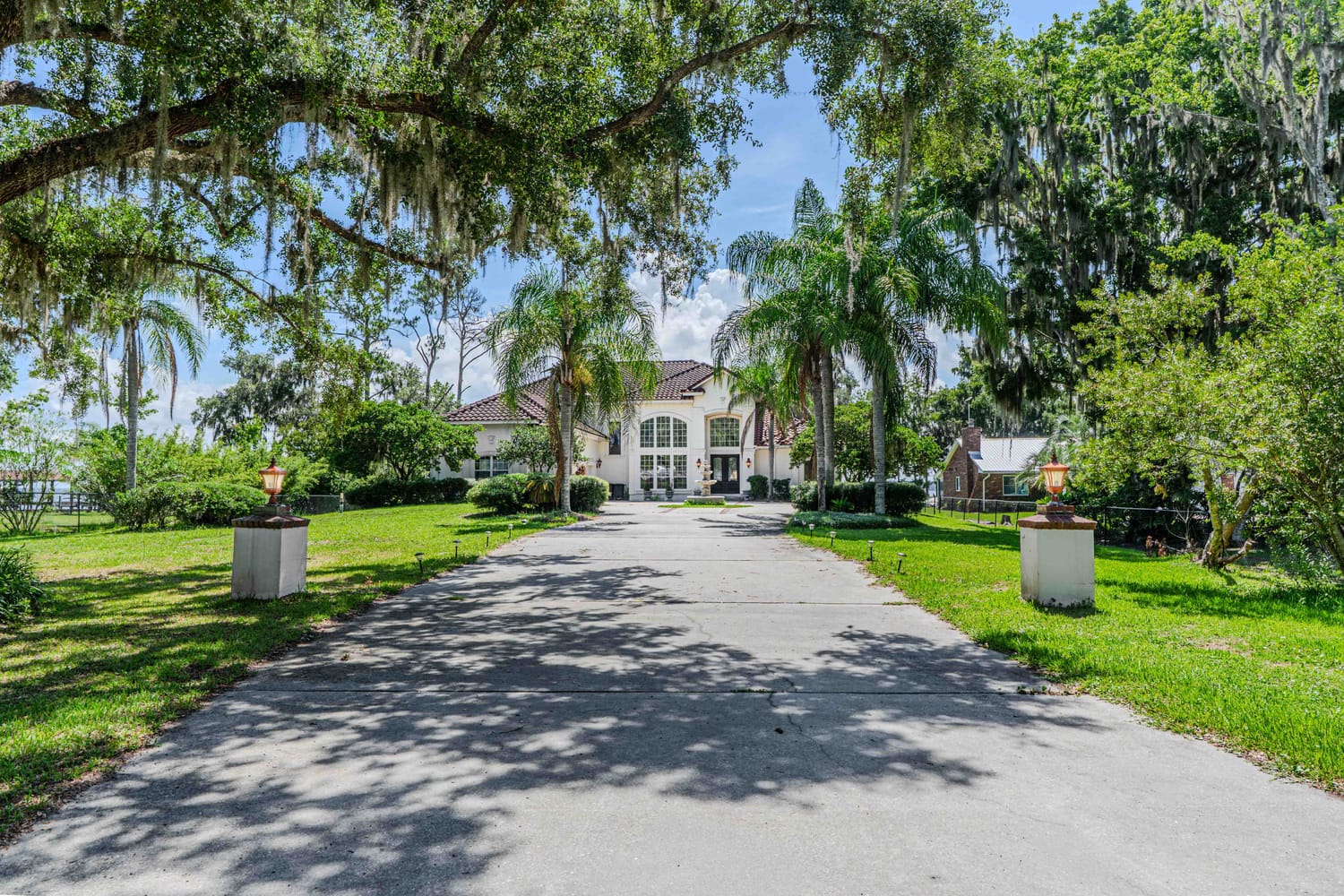 Professional HDR exterior photography of a luxury home in Palatka Florida, showcasing curb appeal and front landscaping