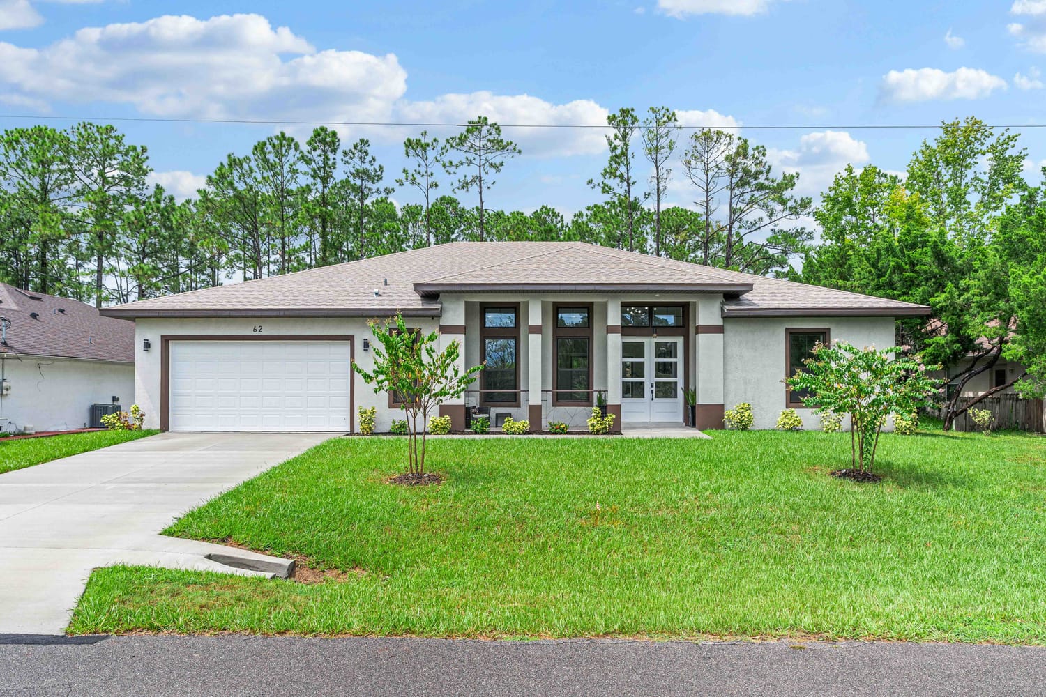 Professional HDR exterior photography of a luxury home in Palm Coast, showcasing curb appeal and front landscaping