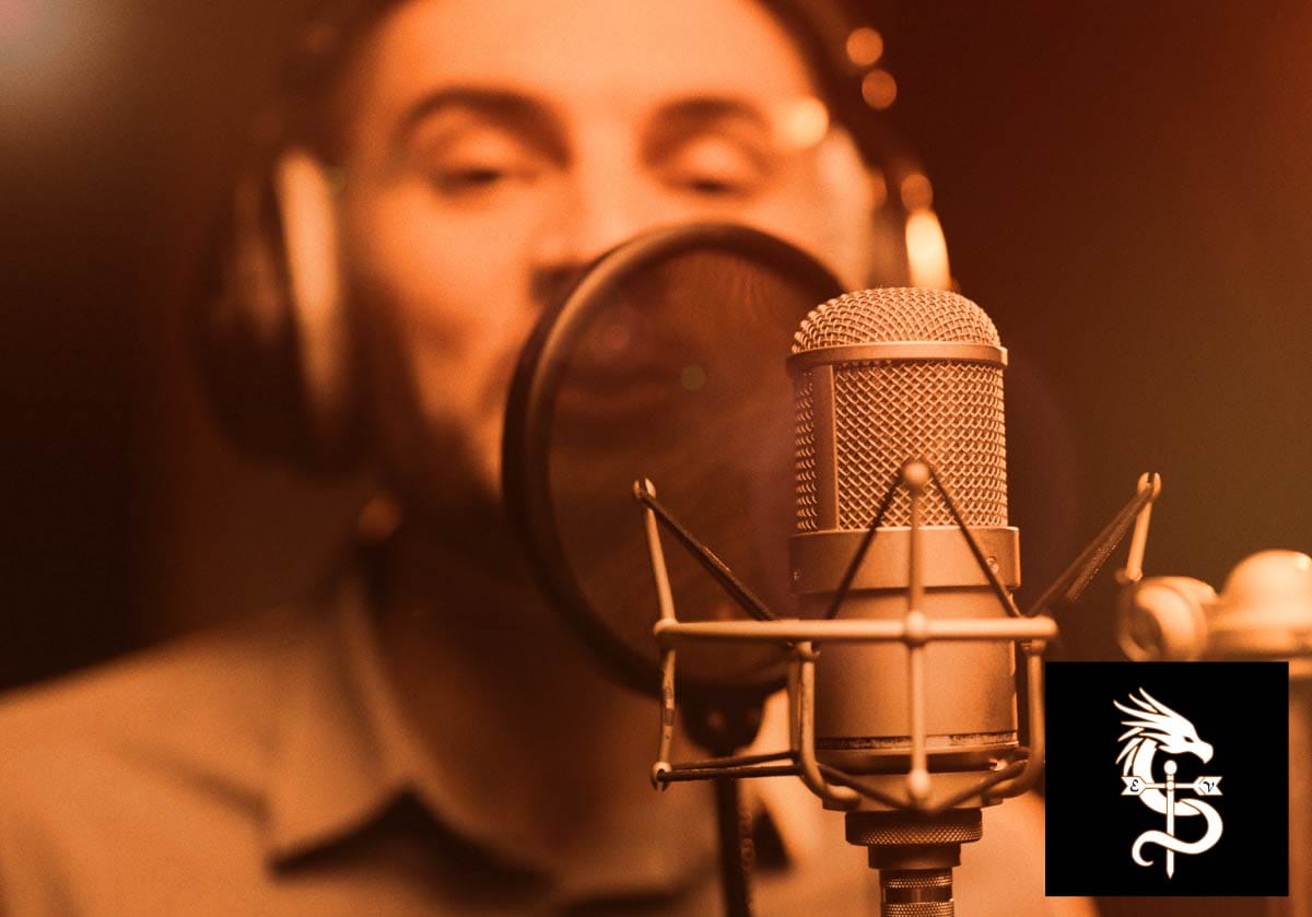 A vocalist wearing headphones performing into a studio condenser microphone.
