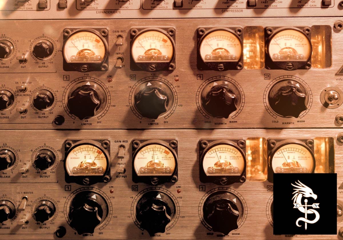 A rack of vintage hardware audio compressors and EQ units with analog meters.