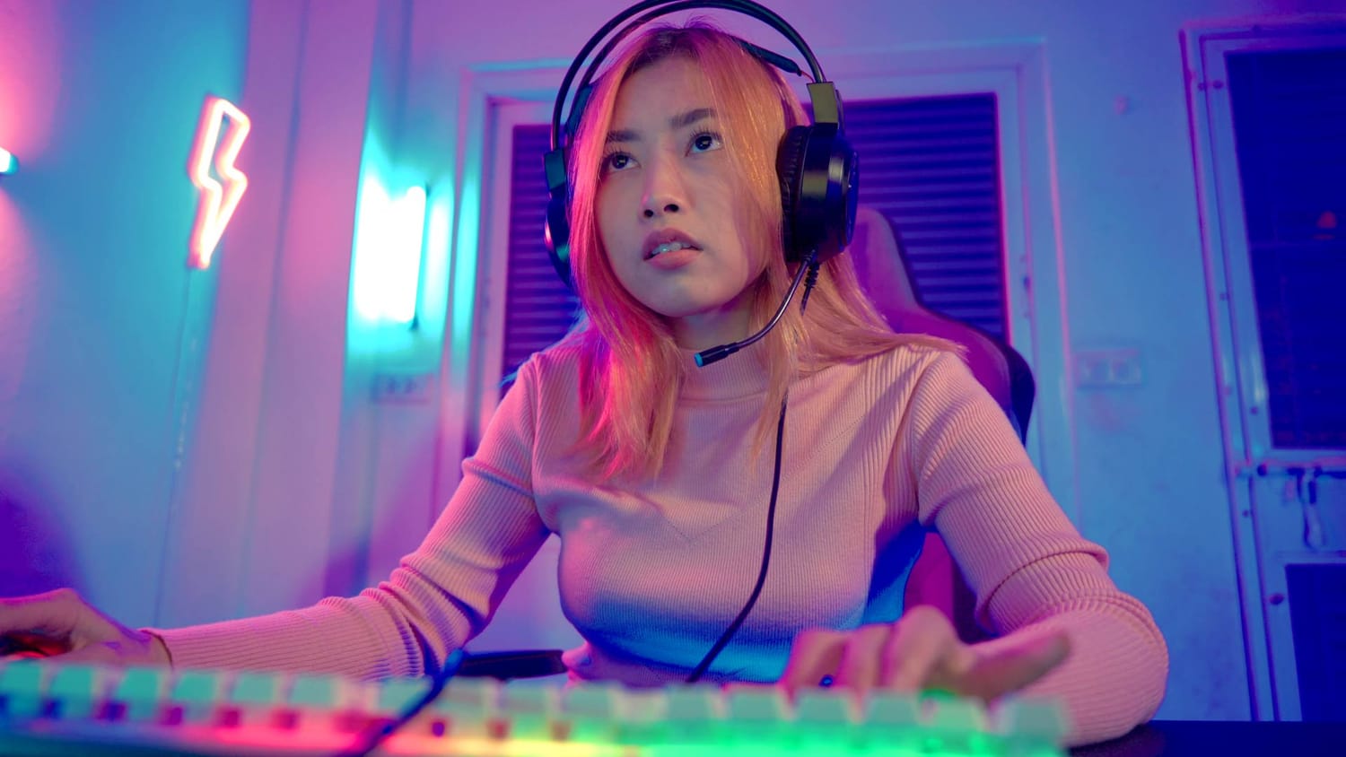 A music producer looking at her computer with a frustrated look, representing the feeling of hitting a stumbling block.