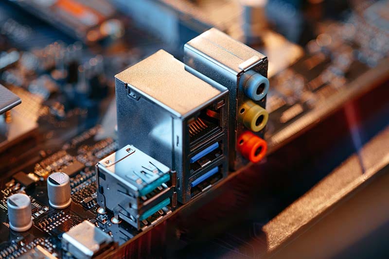 A closeup of audio jacks on a built-in soundcard on a motherboard
